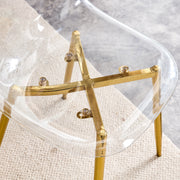 Table and chair set.Modern circular transparent tempered glass table, tempered glass tabletop, golden metal table legs.A Set of  6 Transparent Plastic Chairs with gold legs.